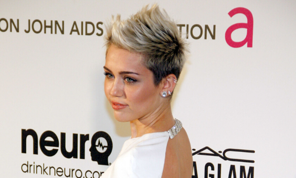 Miley Cyrus em uma premiação usando vestido e cabelo curto