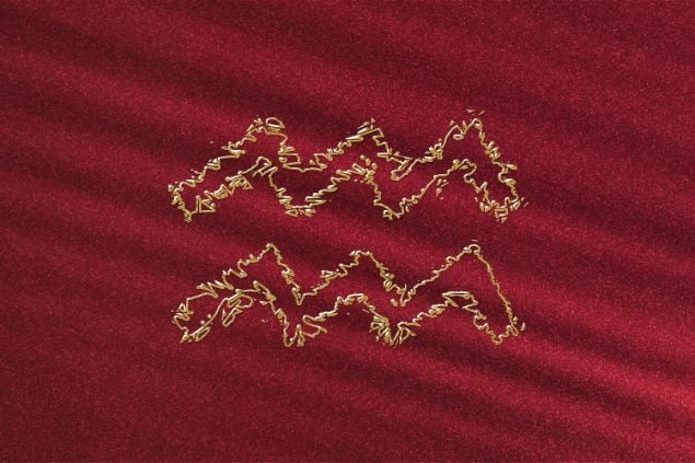 Imagem de fundo vermelho e em destaque o elemento do signo de Aquário no horóscopo