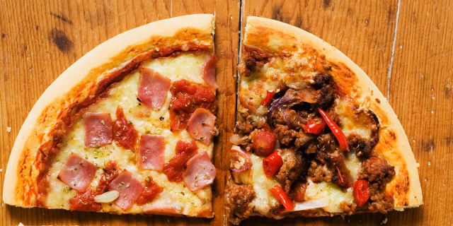 Duas fatias de pizza sobre madeira. 