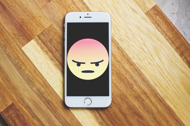 Emoji raivoso num celular.